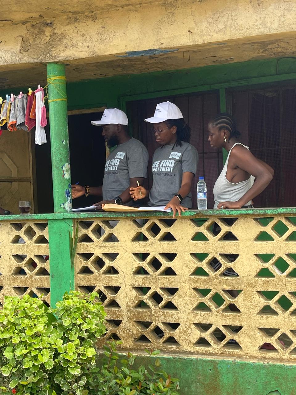 GTL team working on a porch with community members